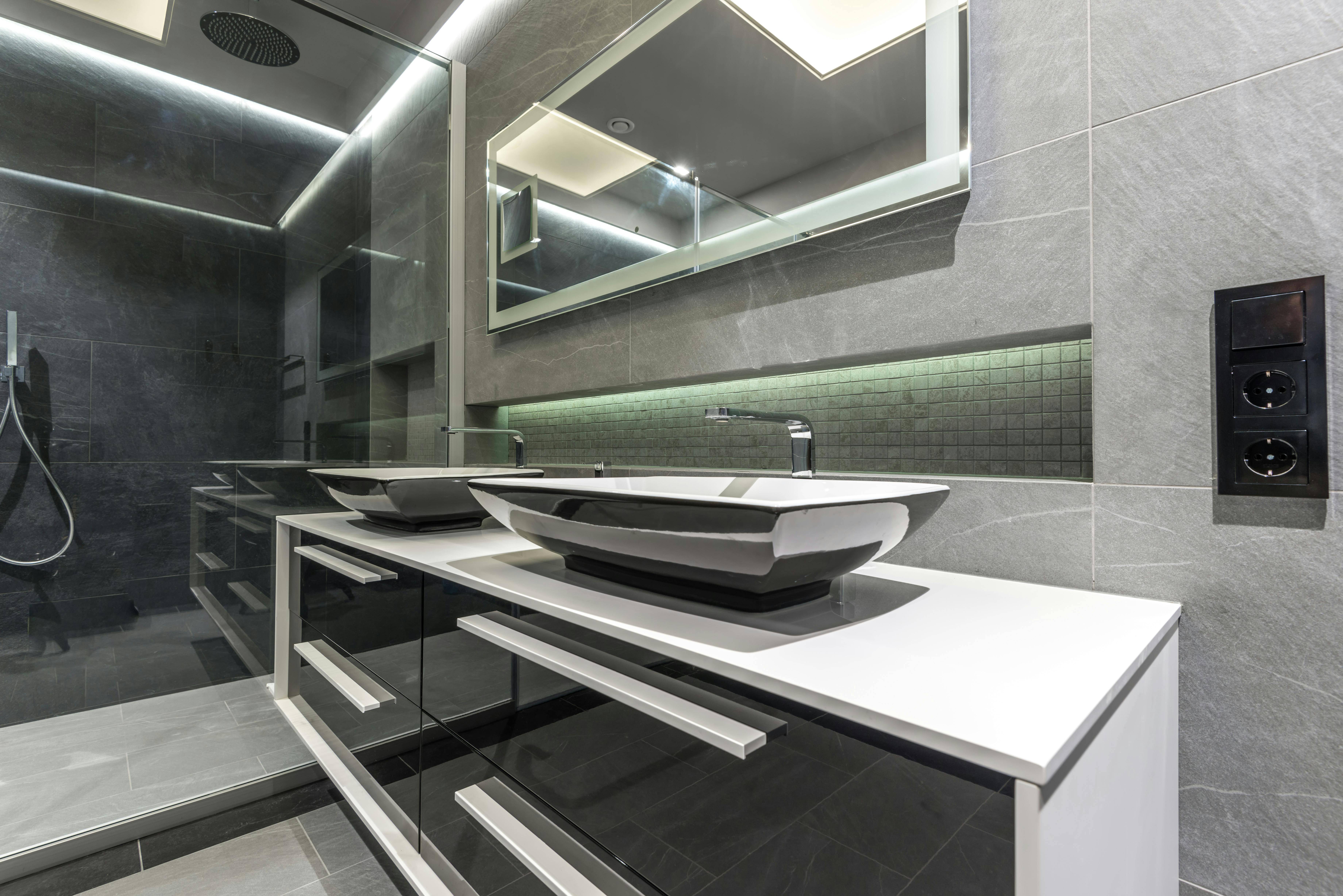 Home 11 a bathroom with a mirror and sinks