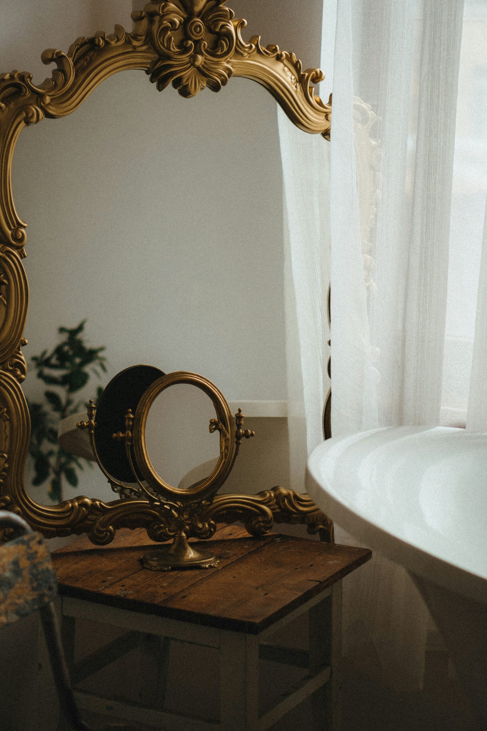 Home 26 a mirror on a table next to a bathtub
